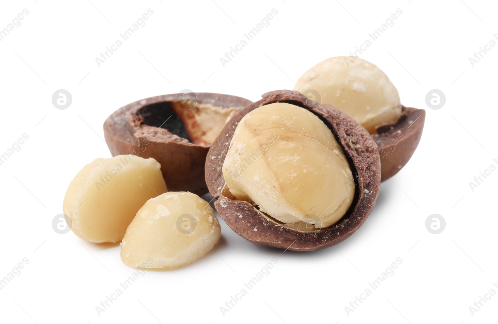 Photo of Macadamia nuts with shells isolated on white