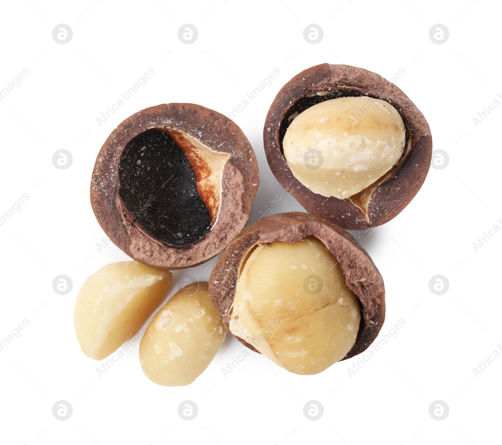 Photo of Macadamia nuts with shells isolated on white, top view