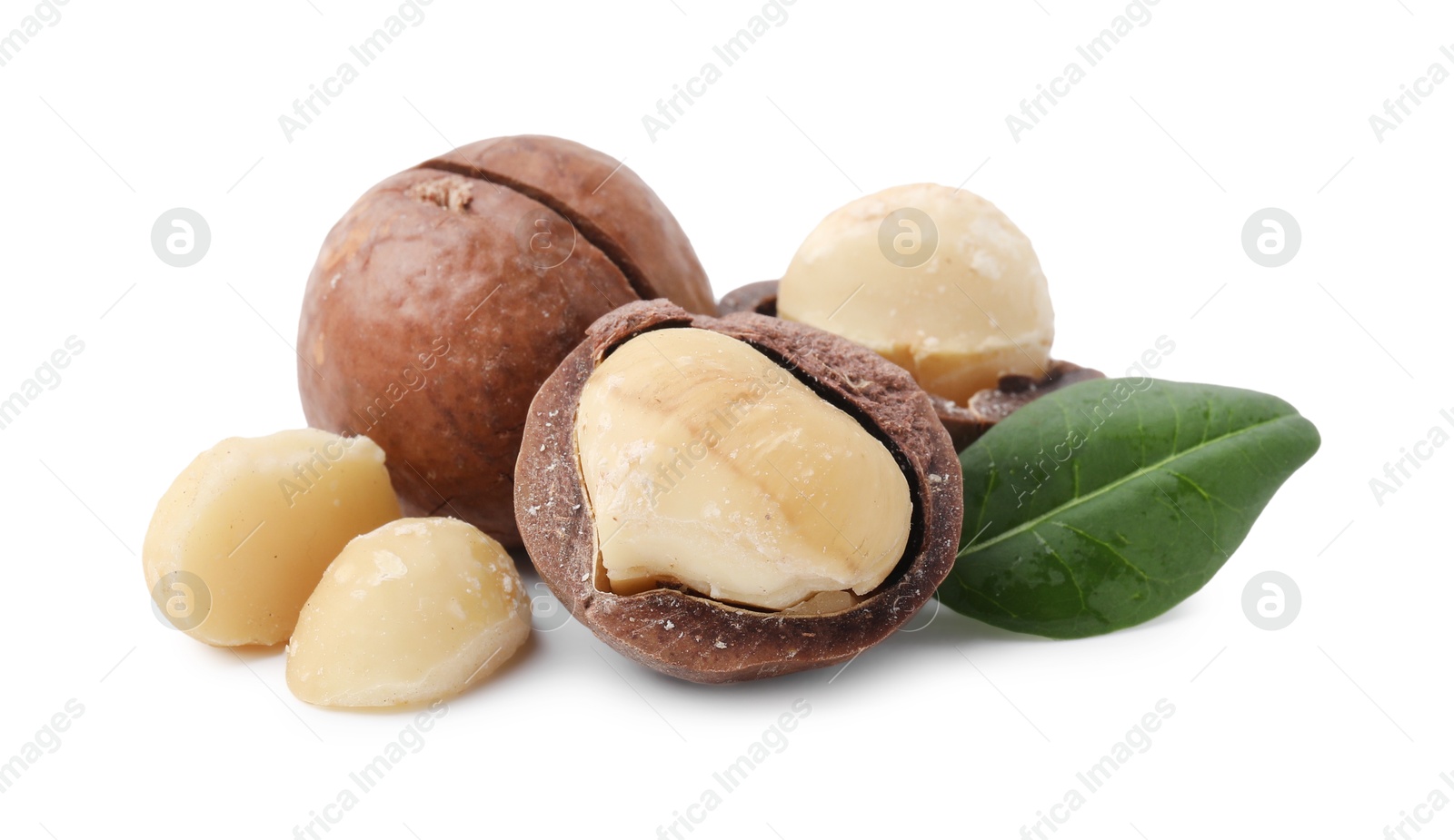 Photo of Macadamia nuts with shells isolated on white