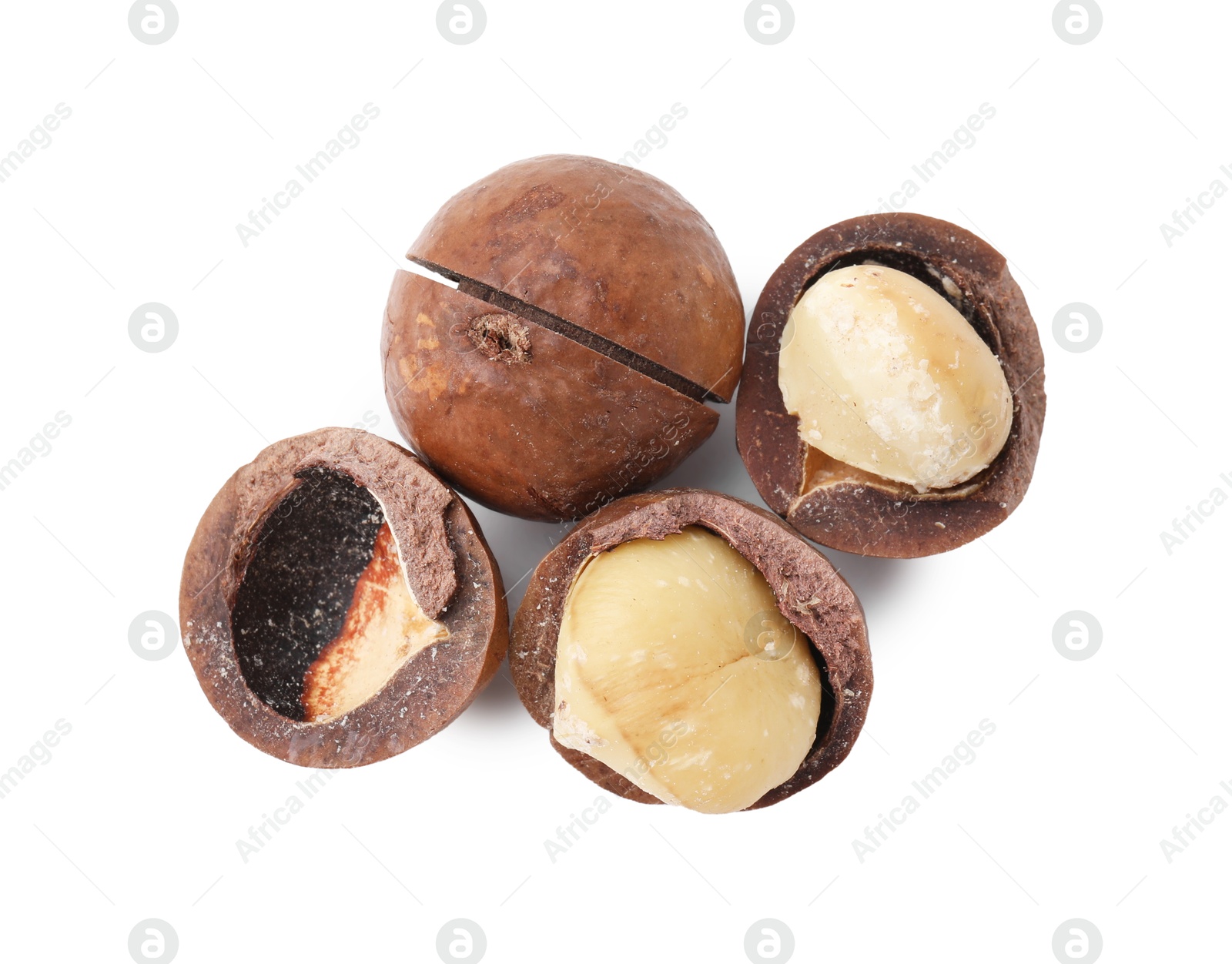 Photo of Macadamia nuts with shells isolated on white, top view