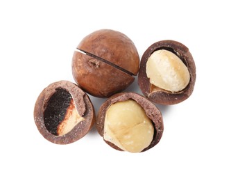 Photo of Macadamia nuts with shells isolated on white, top view