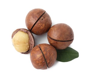 Photo of Macadamia nuts with shells isolated on white, top view