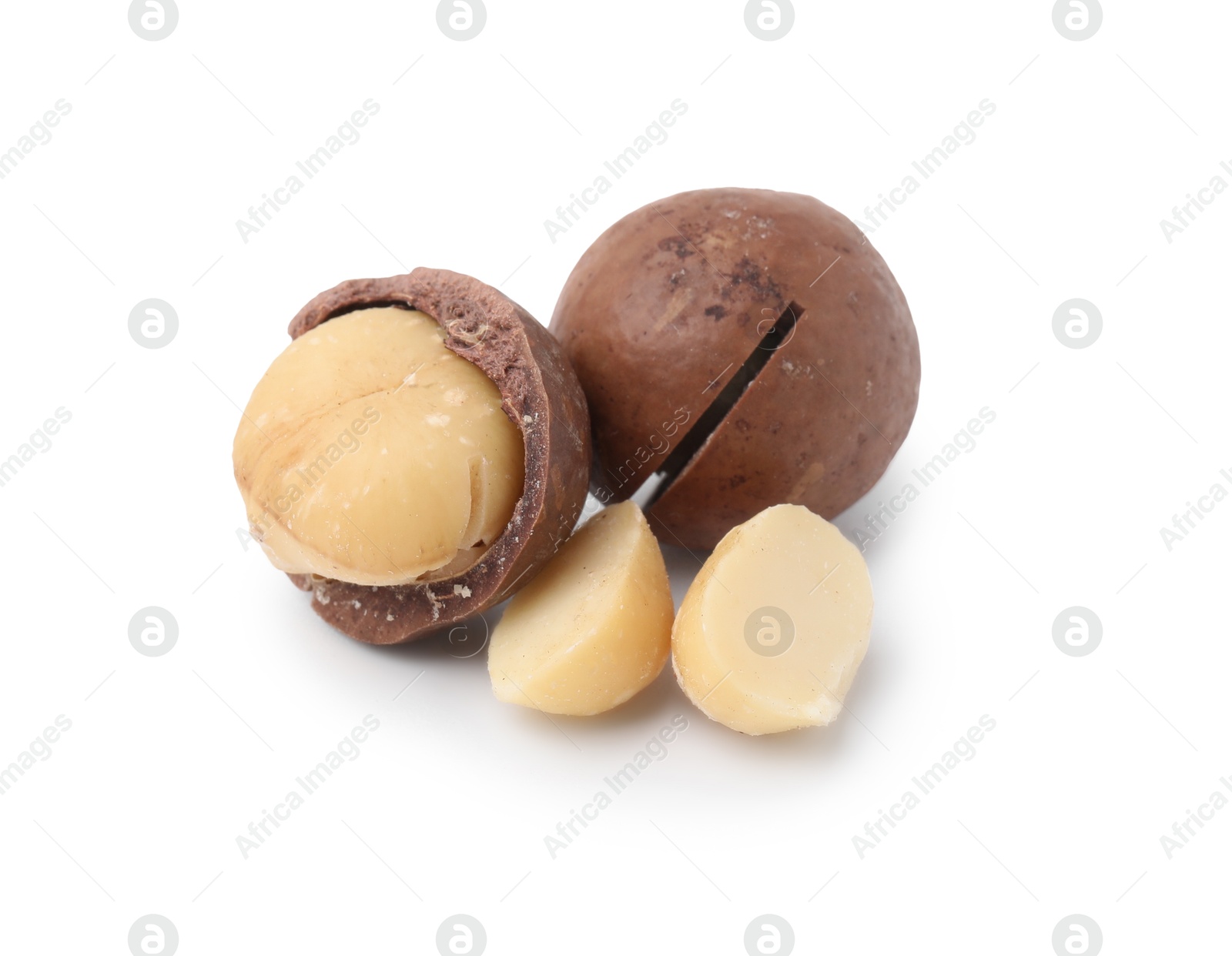 Photo of Macadamia nuts with shells isolated on white