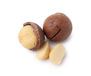 Photo of Macadamia nuts with shells isolated on white