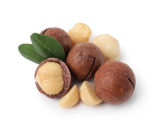 Photo of Macadamia nuts with shells isolated on white