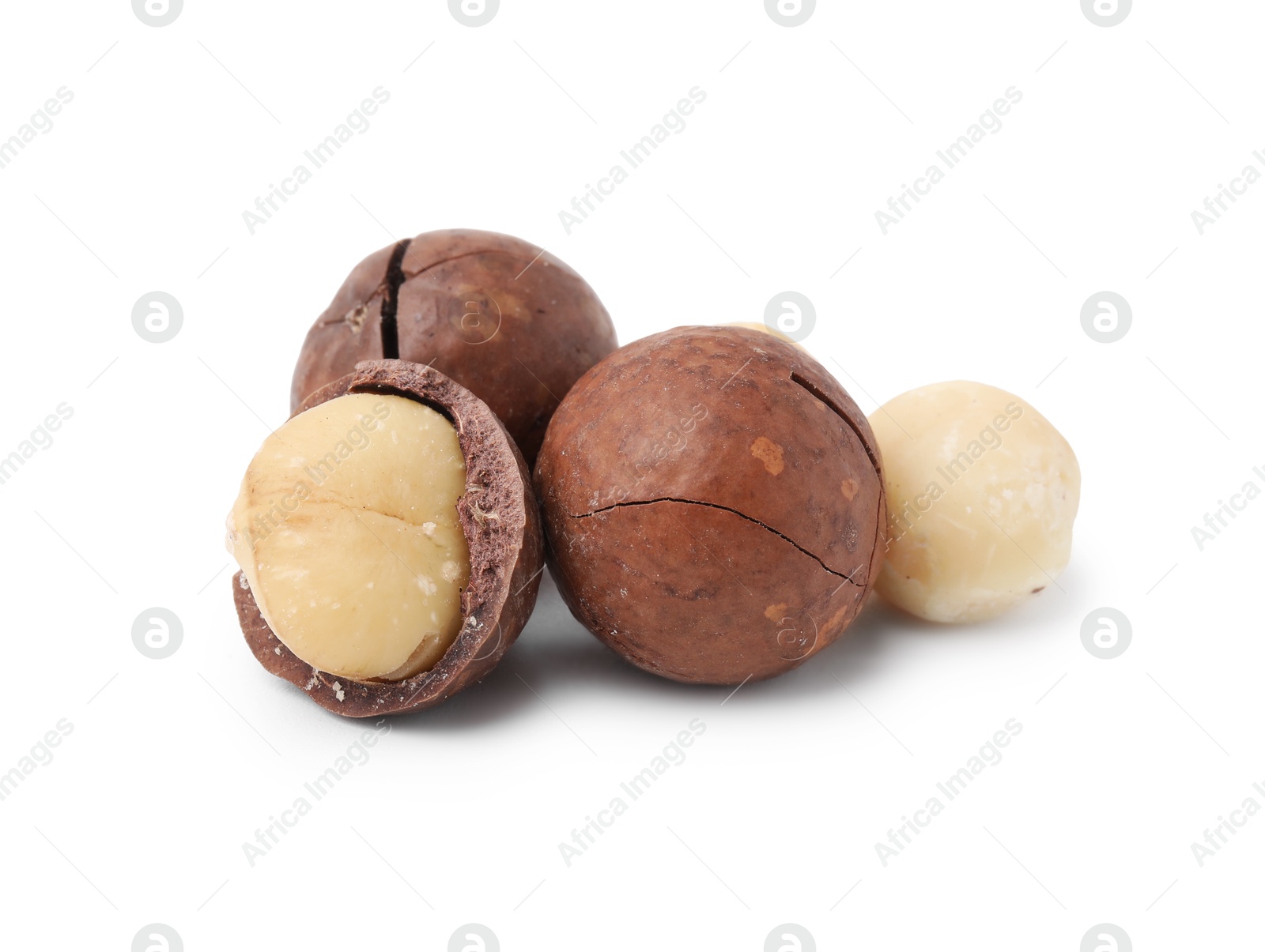 Photo of Macadamia nuts with shells isolated on white