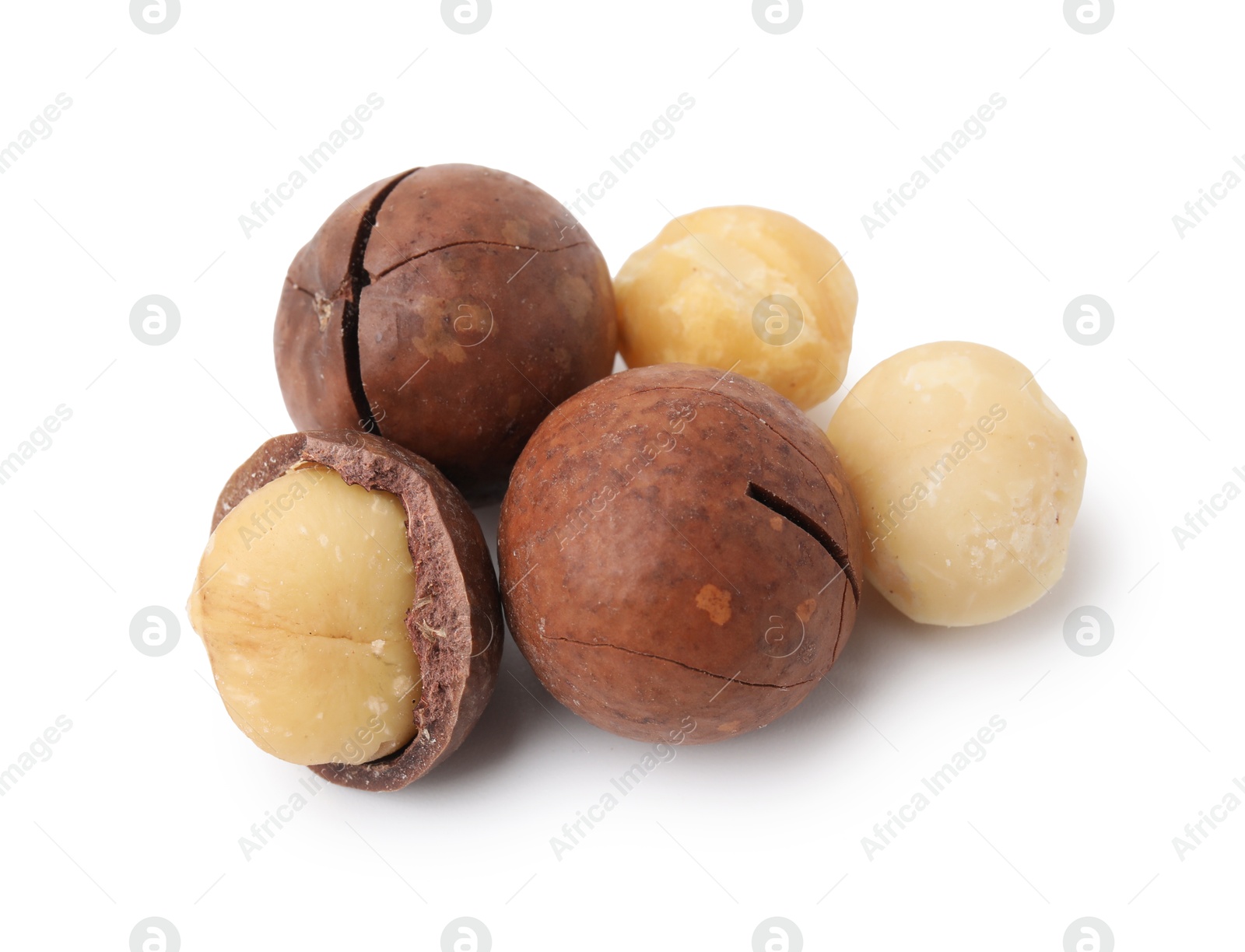 Photo of Macadamia nuts with shells isolated on white