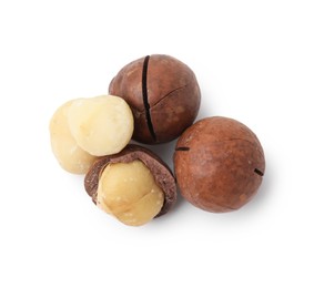 Photo of Macadamia nuts with shells isolated on white, top view