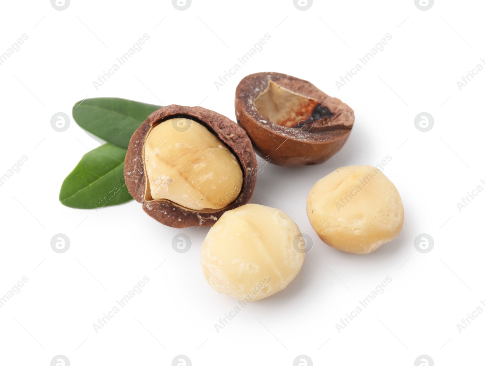 Photo of Macadamia nuts with shells isolated on white