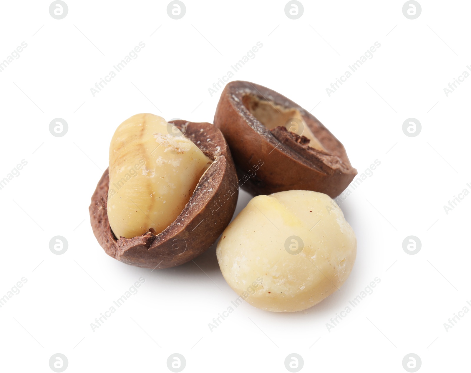 Photo of Macadamia nuts with shells isolated on white