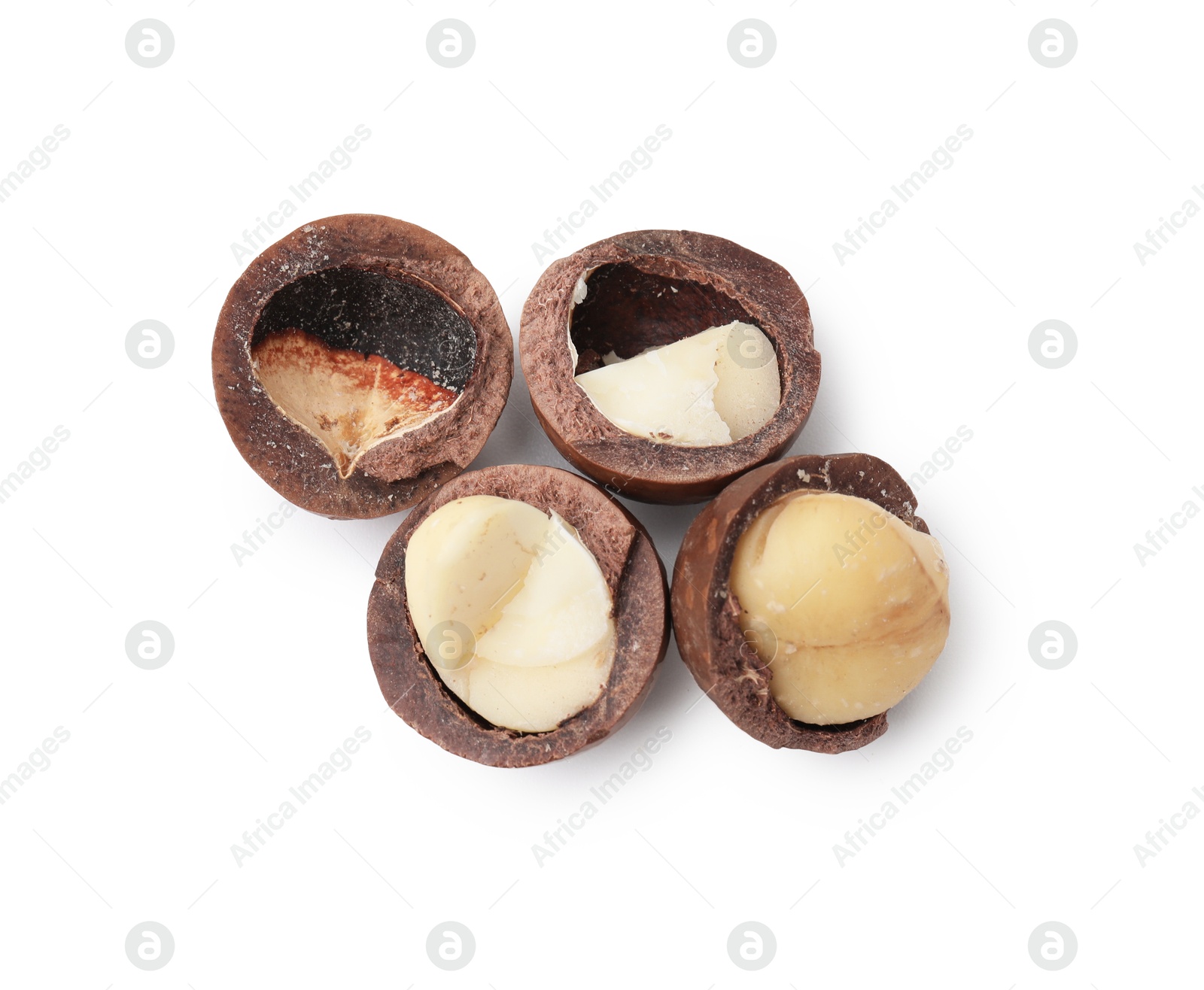 Photo of Macadamia nuts with shells isolated on white, top view