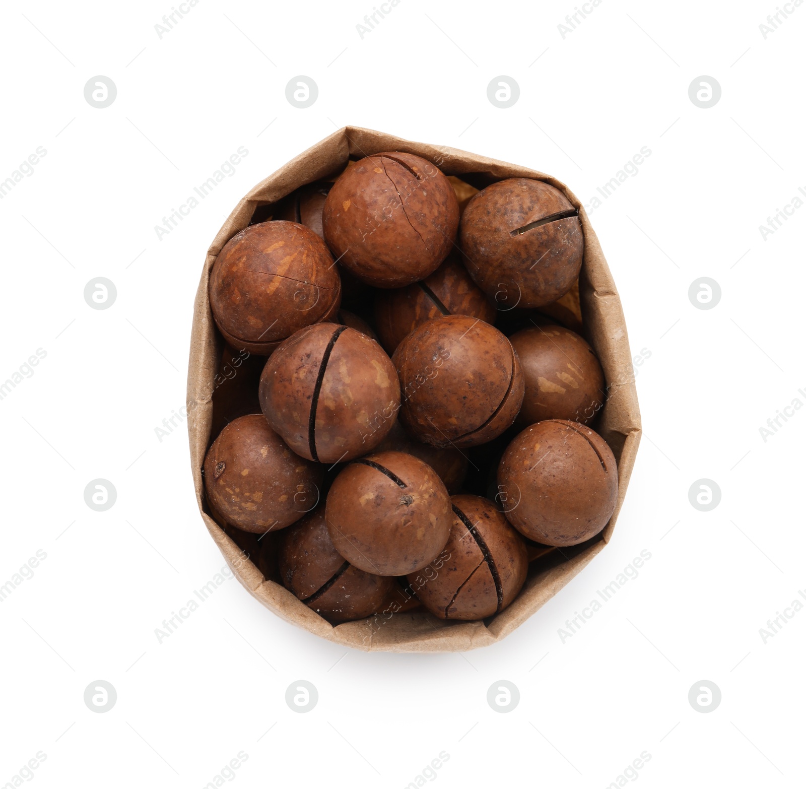 Photo of Macadamia nuts in paper bag isolated on white, top view