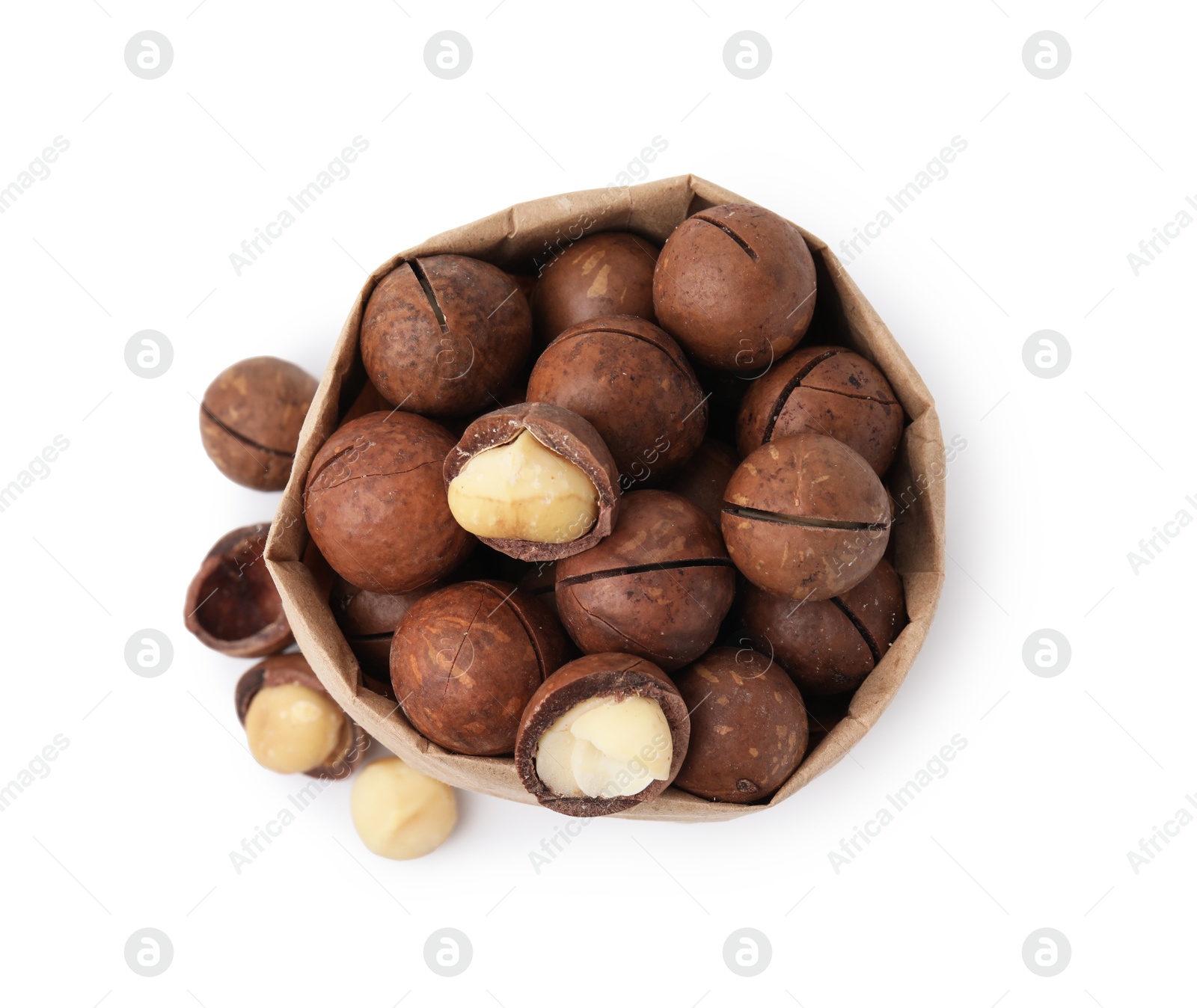 Photo of Macadamia nuts in paper bag isolated on white, top view