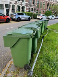 Many green trash bins on city street