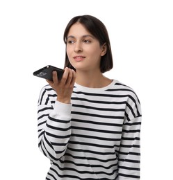 Beautiful woman recording voice message via smartphone on white background