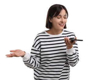 Beautiful woman recording voice message via smartphone on white background