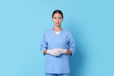 Nurse in medical uniform on light blue background