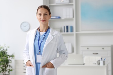 Photo of Portrait of nurse in medical uniform indoors, space for text