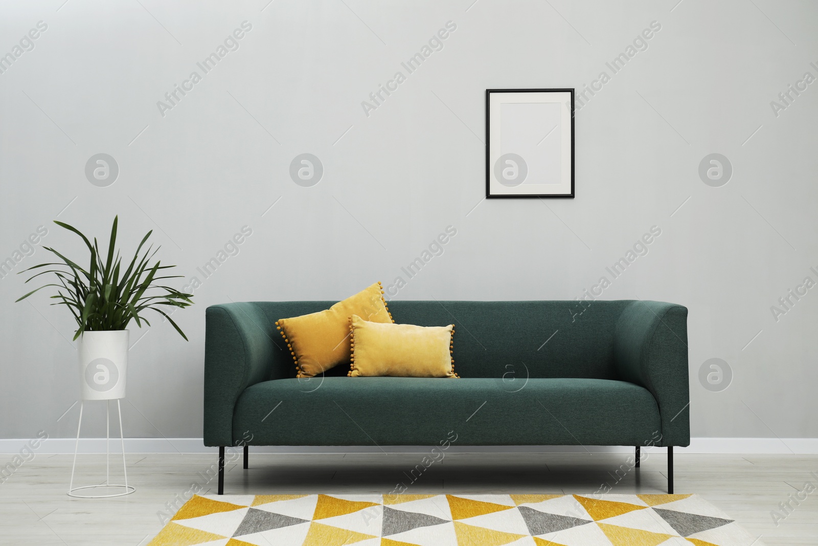 Photo of Stylish room interior with comfortable sofa and houseplant