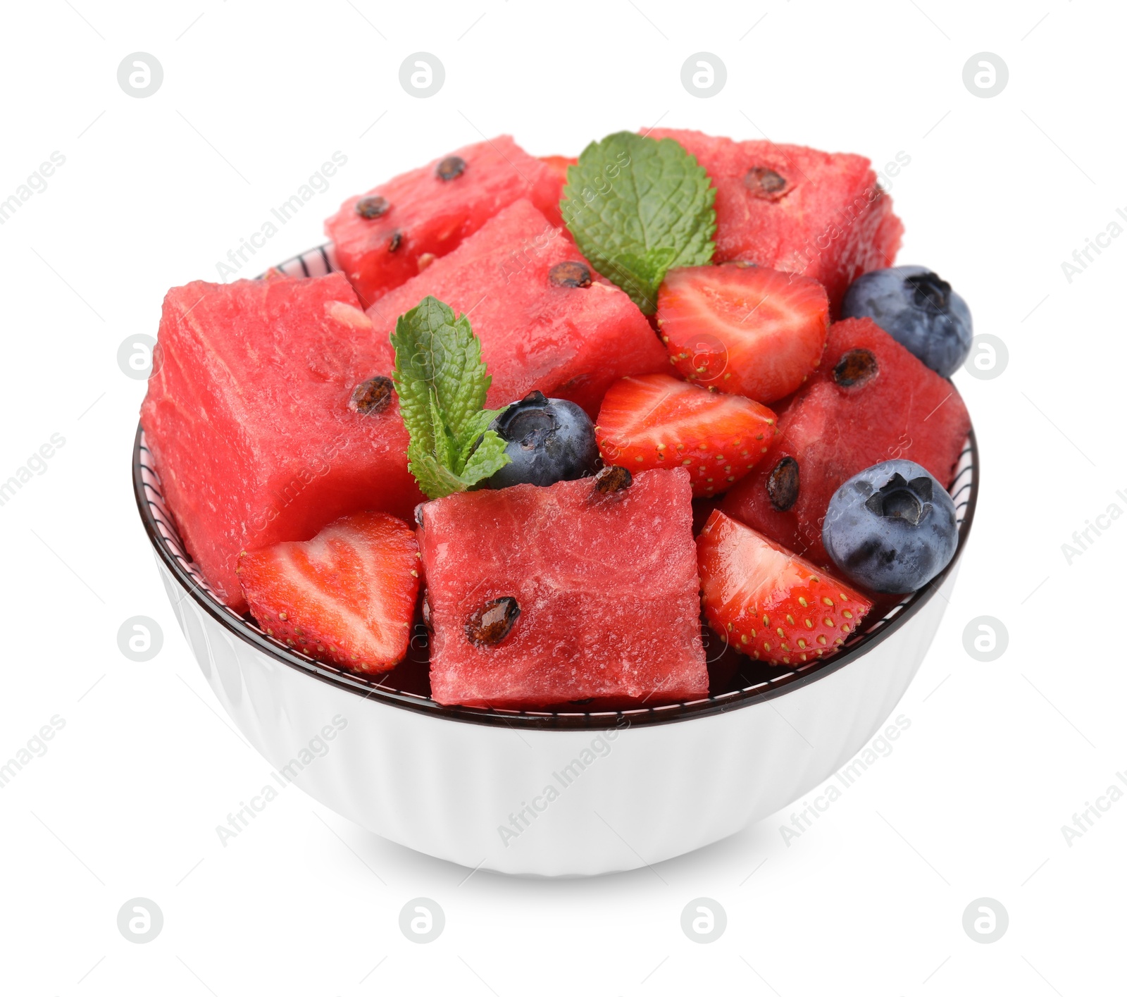 Photo of Pieces of tasty watermelon, strawberries, blueberries and mint in bowl isolated on white