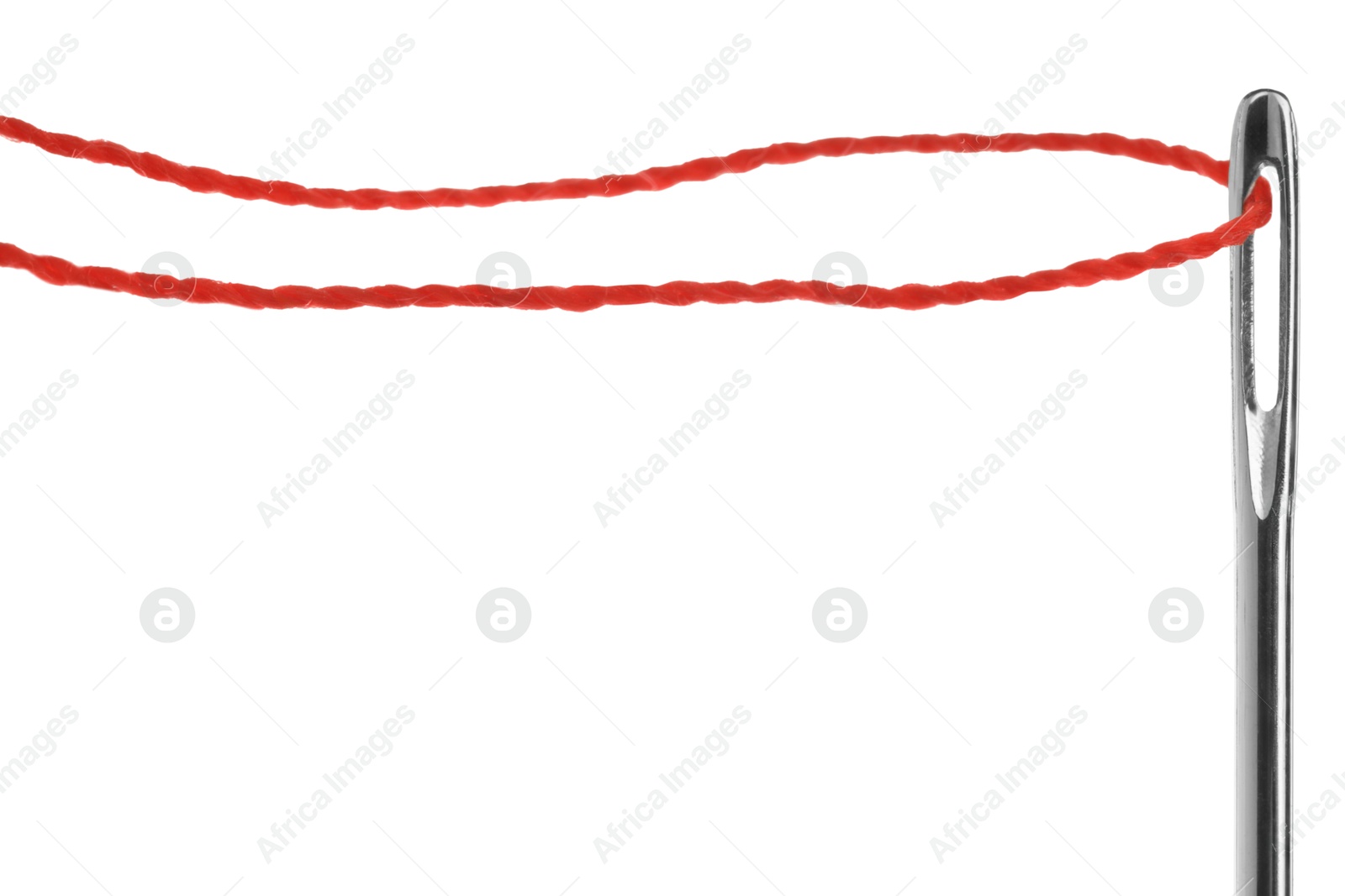 Photo of Sewing needle with red thread isolated on white, closeup