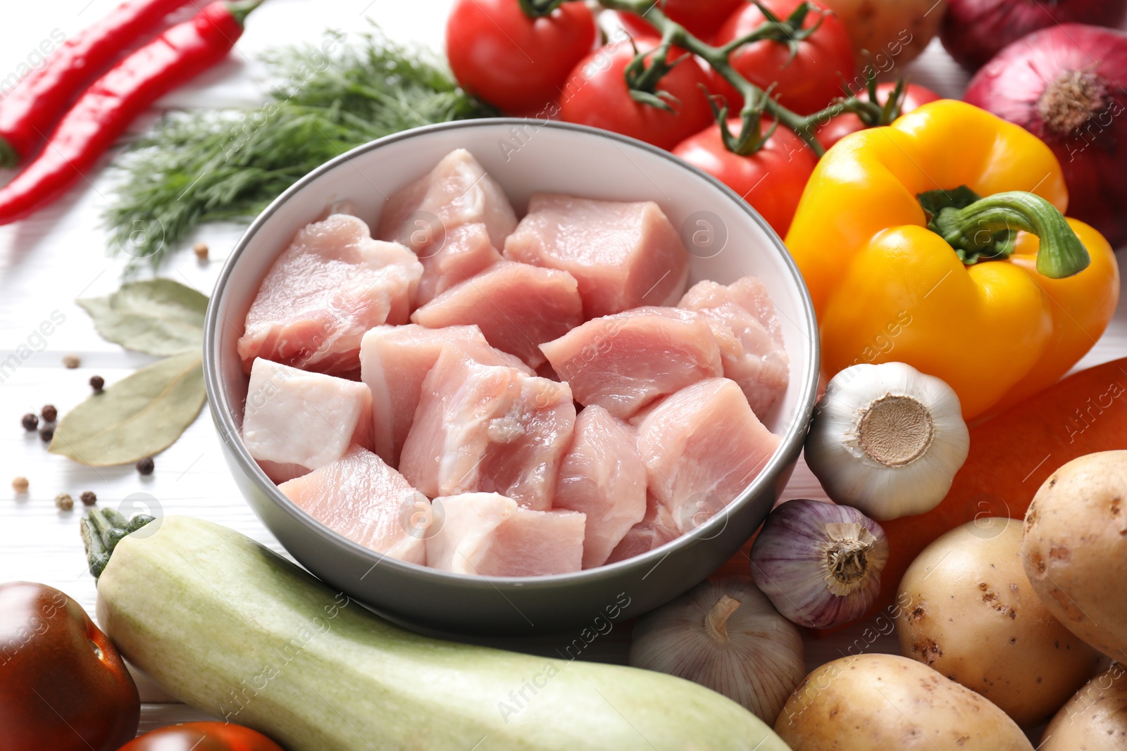 Photo of Uncooked ingredients for stew on white table, closeup