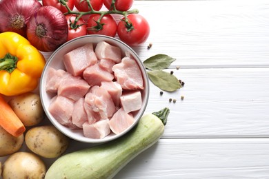 Photo of Uncooked ingredients for stew on white wooden table, flat lay. Space for text