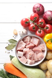 Photo of Uncooked ingredients for stew on white wooden table, flat lay