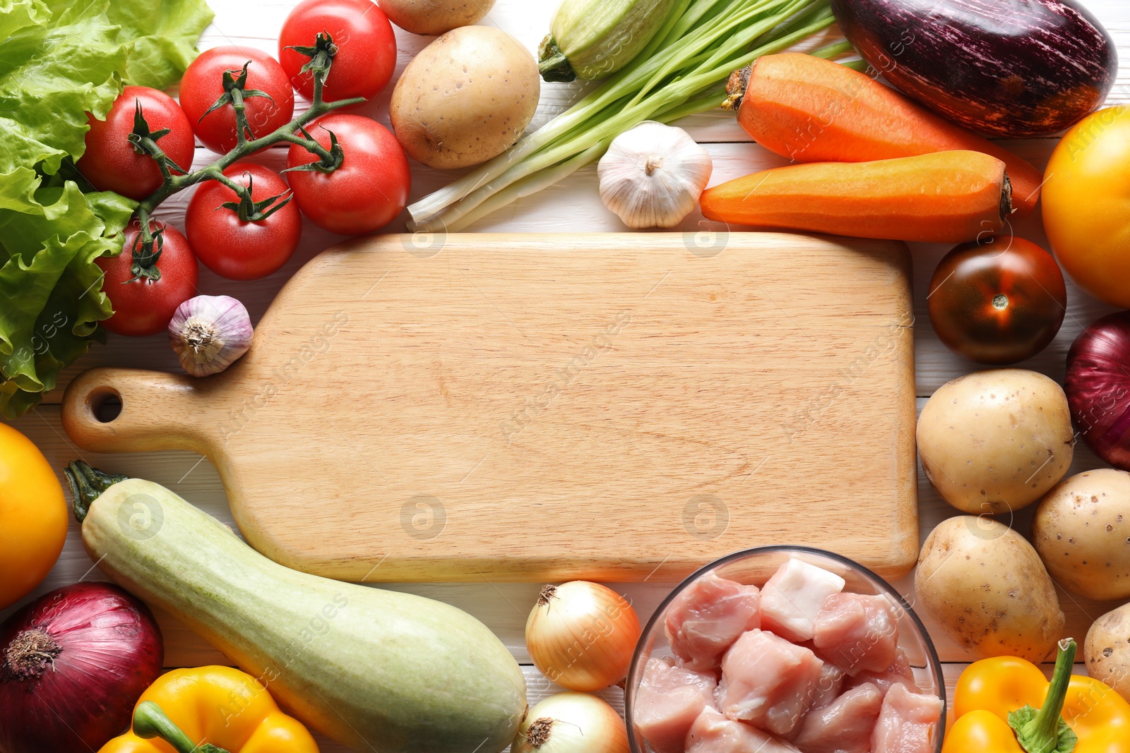 Photo of Uncooked ingredients for stew on white wooden table, flat lay