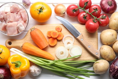 Photo of Uncooked ingredients for stew on white wooden table, flat lay