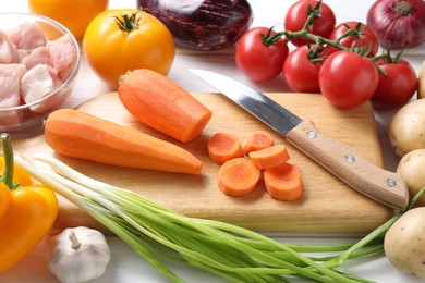 Photo of Uncooked ingredients for stew on white table, closeup