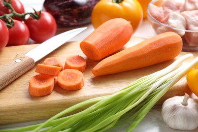 Photo of Uncooked ingredients for stew on white table, closeup