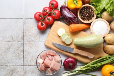 Photo of Uncooked ingredients for stew on tiled table, flat lay