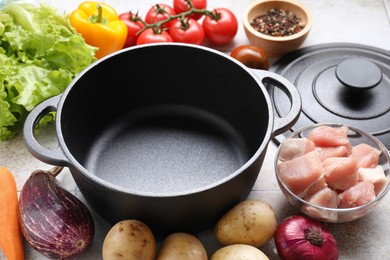 Photo of Uncooked ingredients for stew on tiled table, closeup