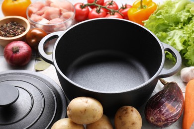 Photo of Uncooked ingredients for stew on tiled table, closeup