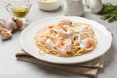 Photo of Delicious pasta with shrimps served on light table, closeup