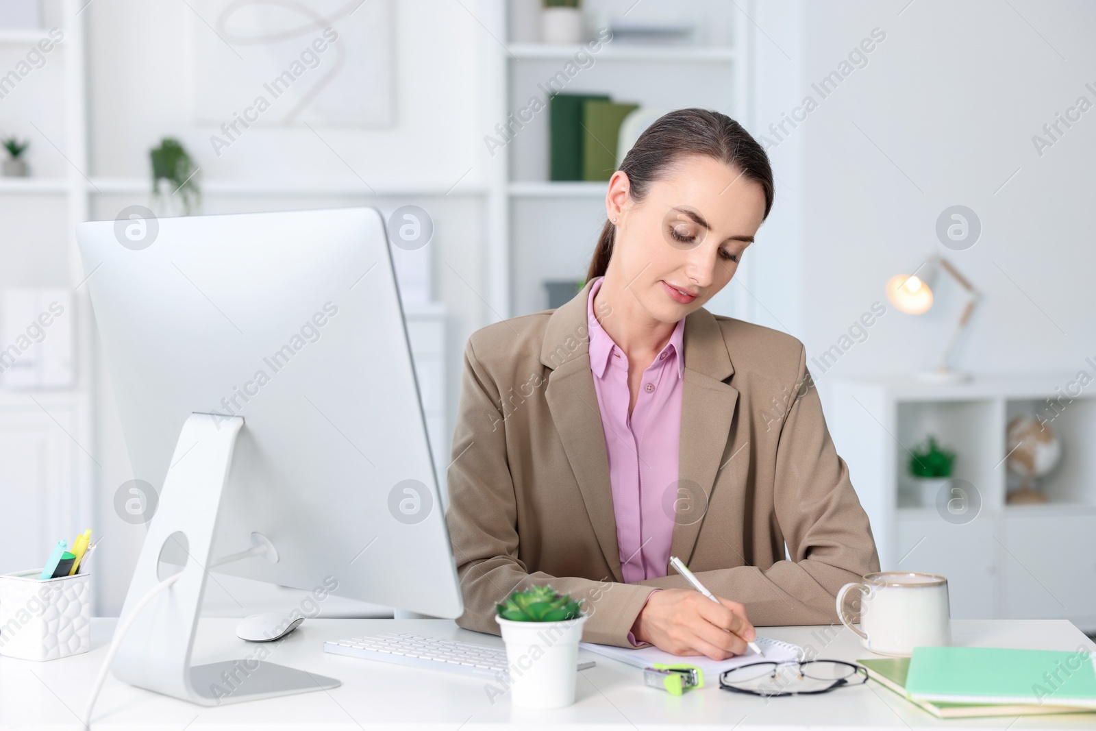 Photo of Beautiful businesswoman working at table in office