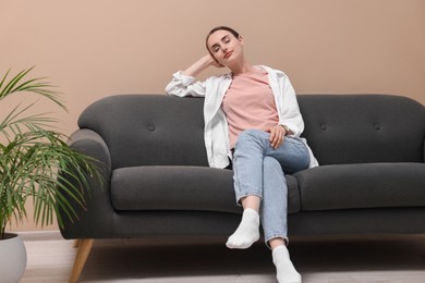 Beautiful woman relaxing on sofa at home