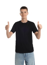 Teenage boy wearing black t-shirt and showing thumbs up on white background