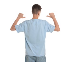 Teenage boy wearing light blue t-shirt on white background, back view