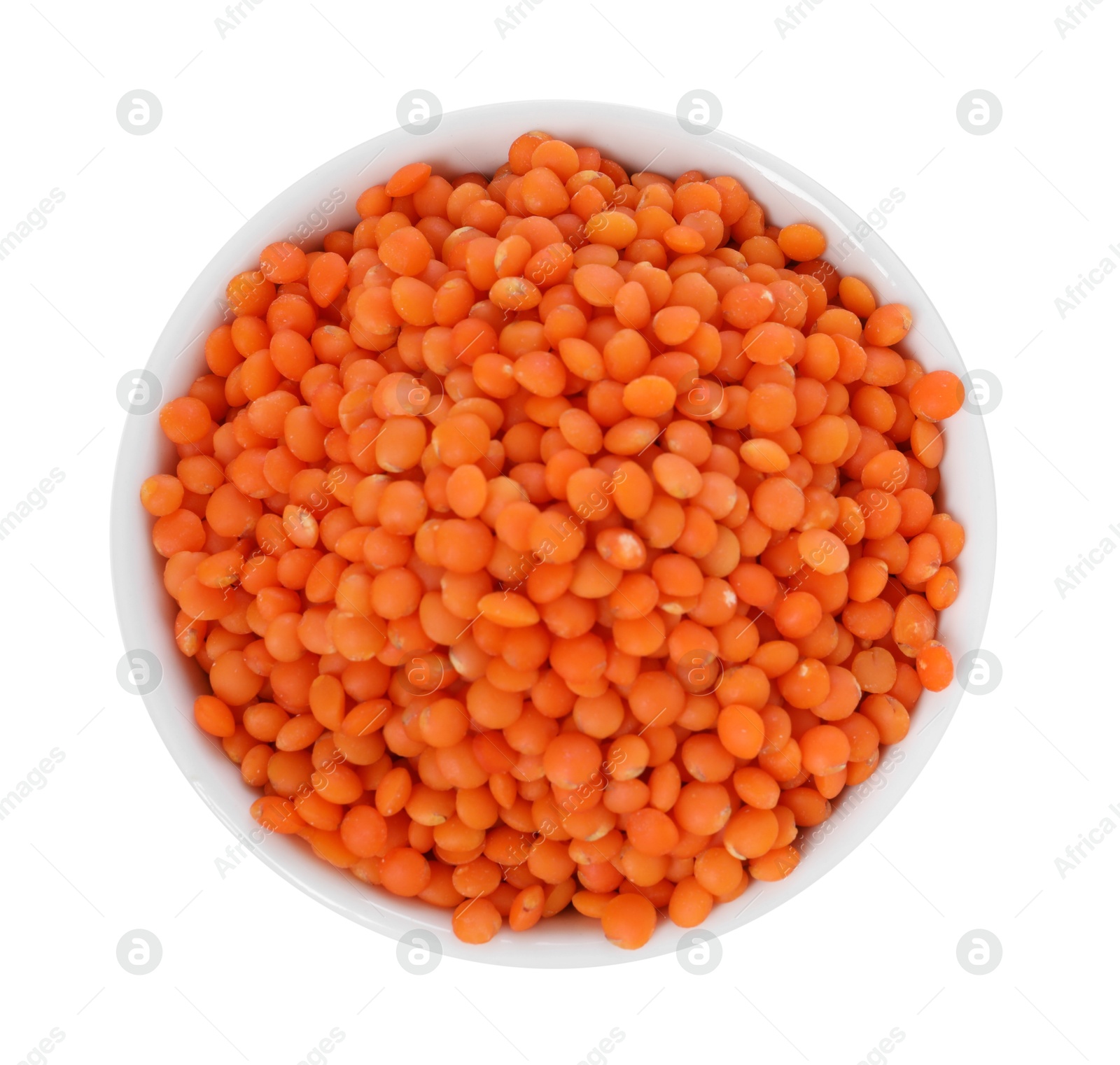 Photo of Raw lentils in bowl isolated on white, top view