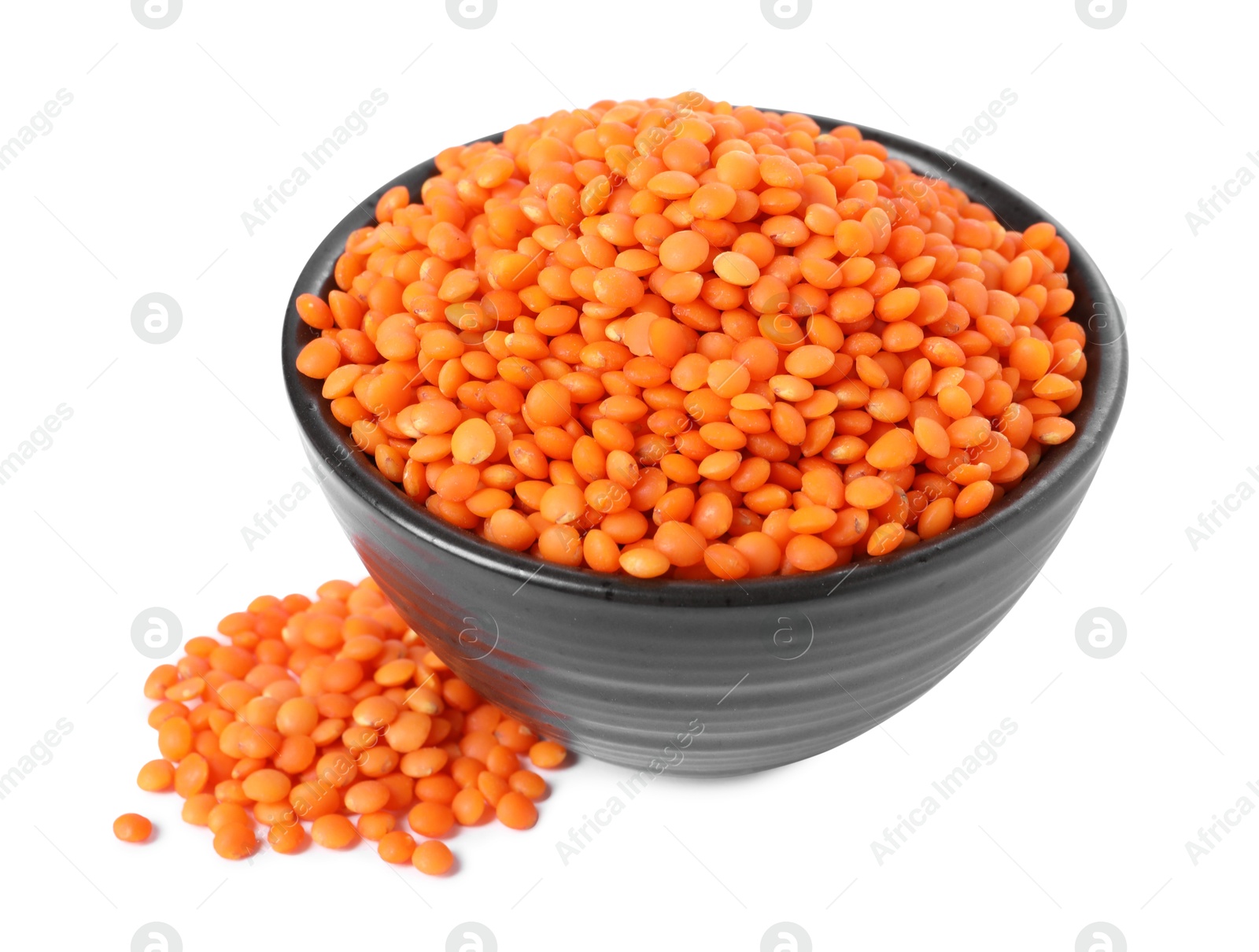 Photo of Raw lentils in bowl isolated on white