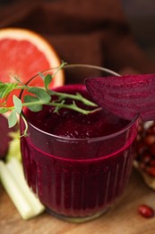 Tasty beetroot smoothie with microgreens in glass on table, closeup. Vegan drink