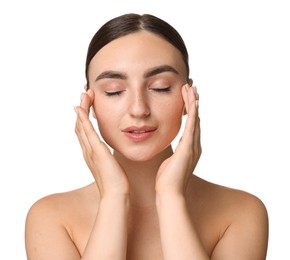 Beautiful young woman doing facial massage on white background