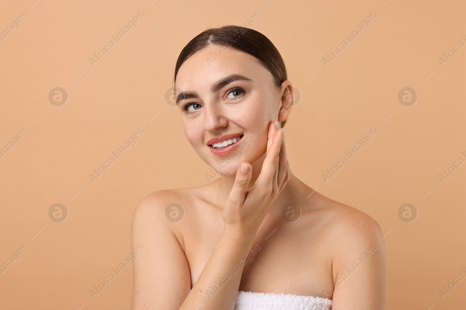 Photo of Beautiful young woman with healthy skin on beige background