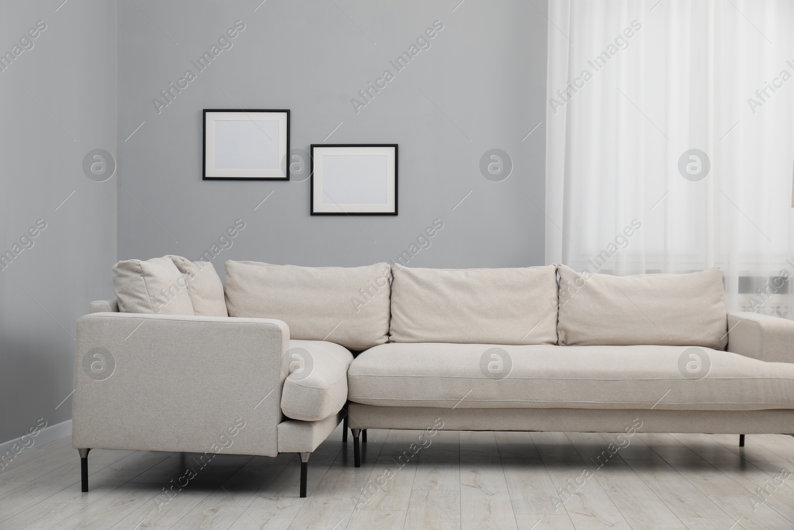 Photo of Stylish room interior with comfortable sofa and window