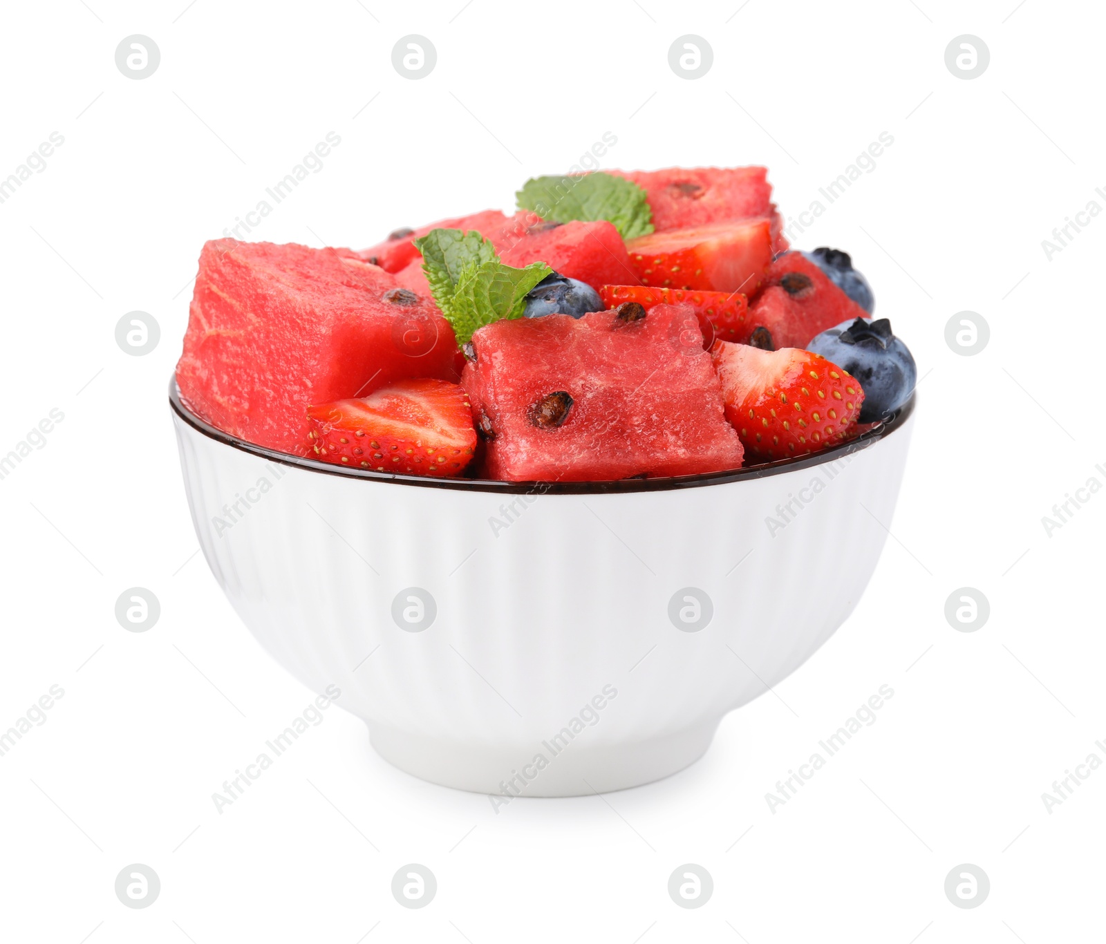 Photo of Pieces of tasty watermelon, strawberries, blueberries and mint in bowl isolated on white