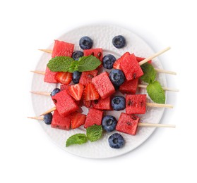 Photo of Skewers with tasty watermelon, strawberries, blueberries and mint isolated on white, top view