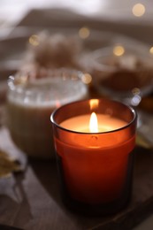 Photo of Tray with burning candle on blurred background. Autumn atmosphere