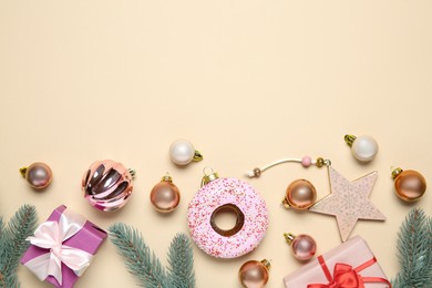 Photo of Flat lay composition with Christmas decor and gift boxes on beige background. Space for text